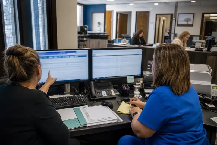 Clinic staff evaluating medical billing software work queues
