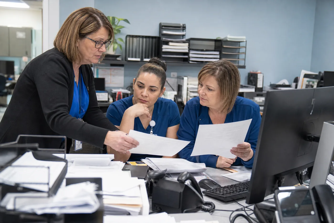 Medical billing team investigating claim denial root causes