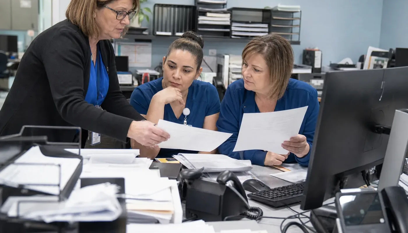 Oncology practice administrators reviewing revenue cycle workflow