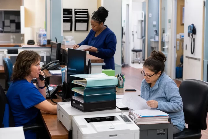 Family medicine staff coordinating front-office and billing work