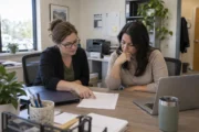 Medical practice administrators reviewing a software proposal