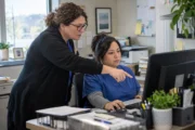 Small medical practice staff reviewing billing software at a shared workstation