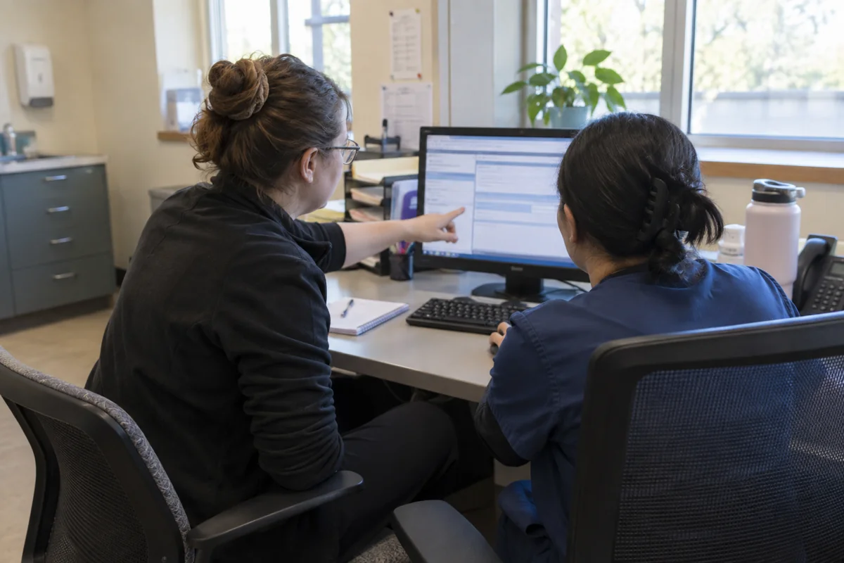 Medical office employees practicing a billing software workflow