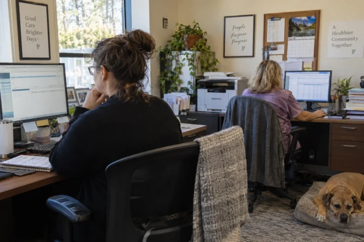 Practice manager and biller testing cloud medical billing software in an ordinary office